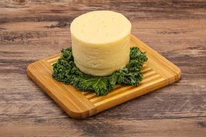 Yellow round dairy soft cheese photo