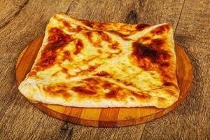 Georgian cuisine - Adjarian khachapuri with cheese photo