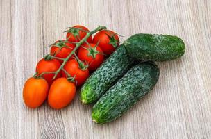 Cucumbers and tomatoes on the branch photo