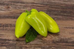 Green bell pepper over wooden background photo