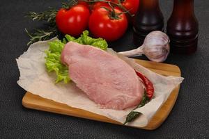 Raw Turkey steak served rosemary photo