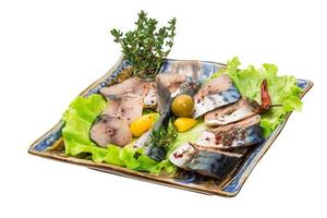 Mackerel fish, sliced on a plate with lettuce photo