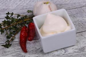 Mayonnaise sauce in the white bowl served thyme and garlic photo