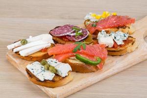 Tapas with cheese, salami and salmon photo