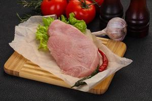 Raw Turkey steak served rosemary photo
