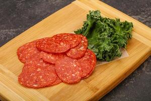 Italian spycy pepperoni sausage slices photo