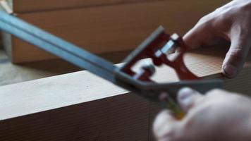 woodworker marks the workpiece with the help of a miter and a pencil video