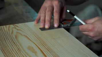 woodworker marks the workpiece with the help of a miter and a pencil video