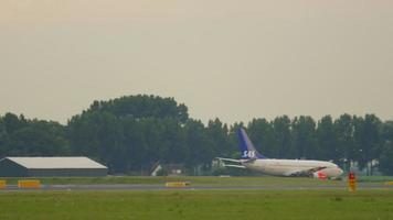 AMSTERDAM, THE NETHERLANDS   JULY 24, 2017 - View of airfield and traffic at Amsterdam airport. Airplanes of Flybe, SAS, EasyJet in line for the runway. Aircraft KLM departure video