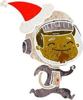 happy retro cartoon of a astronaut wearing santa hat vector