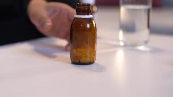 Suicide attempt, pills. The man who spills the pills on the table will commit suicide. video