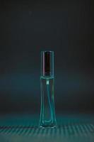 Perfume bottle on the table, black background photo