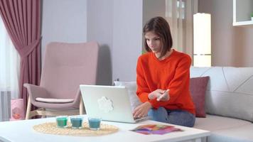 Woman working thoughtfully on laptop. Work from home lifestyle. video
