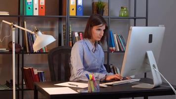 portrait de femme d'affaires positive. jeune femme prenant des notes tout en travaillant sur ordinateur. video