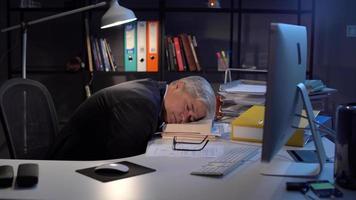 Manager or employee falling asleep in office. Tired of working hard, man falls asleep in his office. video