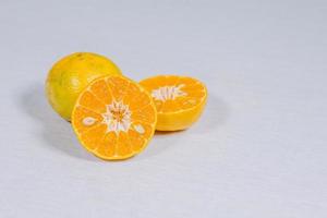 Sweet orange cut into pieces on white background, selective focus, soft focus. photo