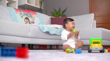 Baby funny posture and gaze. Fun and funny body states of the baby playing with his toys. This is a Slow motion video. video