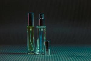 Perfume bottle on the table, black background photo