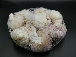 Garlic for sale has cladding material. photo
