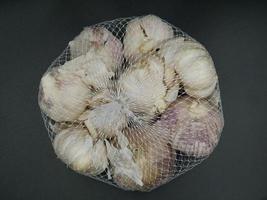 Garlic for sale has cladding material. photo