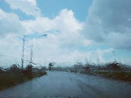 Blurred image in front of car windshield when it rains photo