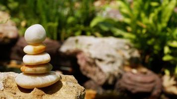 The Balance Stones are stacked as pyramids in a soft natural bokeh background, representing the calm philosophical concept of Jainism's wellness. photo