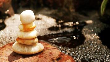 The Balance Stones are stacked as pyramids in a soft natural bokeh background, representing the calm philosophical concept of Jainism's wellness. photo