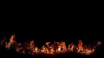 Haystack fires at night in arid areas The ash erupted and the wind was very dangerous. ashes red as hell. photo