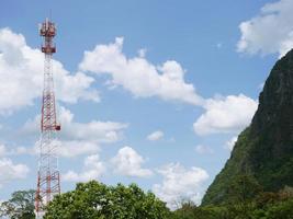 Telephone tower with white clouds in the background. photo