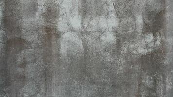 The old cement wall was weathered, the surface was scratched, the surface was scratched and damaged. For a mysterious retro-conservative background. photo