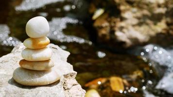 The Balance Stones are stacked as pyramids in a soft natural bokeh background, representing the calm philosophical concept of Jainism's wellness. photo