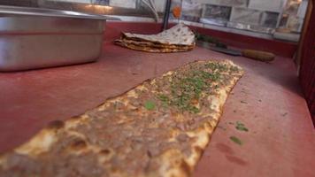 Parsley on the pita. Turkish pita. The cook adds parsley to the pita. video