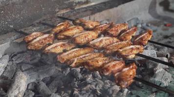 Crispy grilled chicken wings. Chicken wings are cooked on grill charcoal. video