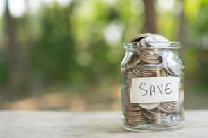 Coins in glass jar for money saving financial concept photo