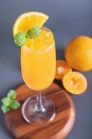 Fresh orange juice in glass with mint, fresh fruits. selective focus. photo