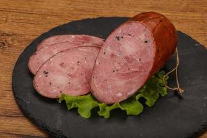 Smoked ham sausage with spices photo