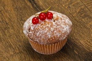 Sweet tasty muffin with red currants photo