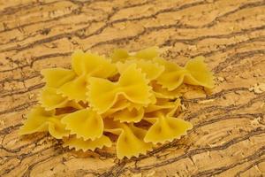 Raw dry farfalle pasta for cooking photo