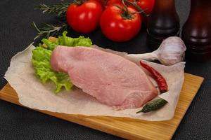 Raw Turkey steak served rosemary photo