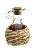 Small decanter with red wine vinegar isolated on the white photo