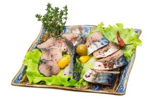 Mackerel fish, sliced on a plate with lettuce photo