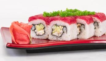 Maki Sushi - Roll made of Crab, avocado, cucumber inside. Fresh Tuna and tobico roe outside photo