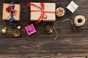 christmas holiday gift shopping background. view from above with copy space. craft paper present boxes tied from rope on blue background, top view. flat lay composition for birthday. photo