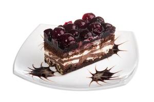 Chocolate cake with cherry on top on a white background photo