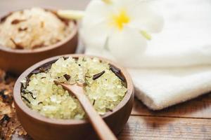 Composition of spa treatment. Natuaral cosmetics with pink himalayan spa salt. Sea bath salt for spa relaxation on wooden background. photo