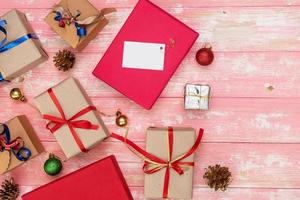 christmas holiday gift shopping background. view from above with copy space. craft paper present boxes tied from rope on blue background, top view. flat lay composition for birthday. photo