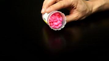 Open pill bottle spilled onto table video