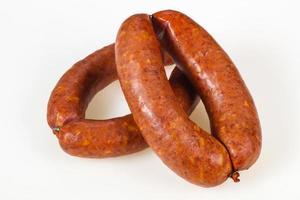 Tasty meat sausages over white background photo