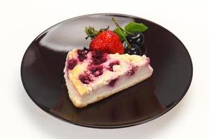 tarta de queso con fresa servida con cereza foto