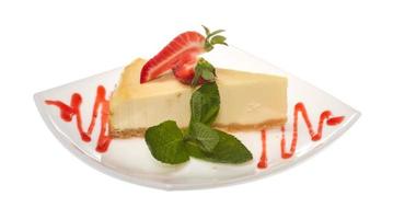 a piece of strawberry cheesecake on whit photo